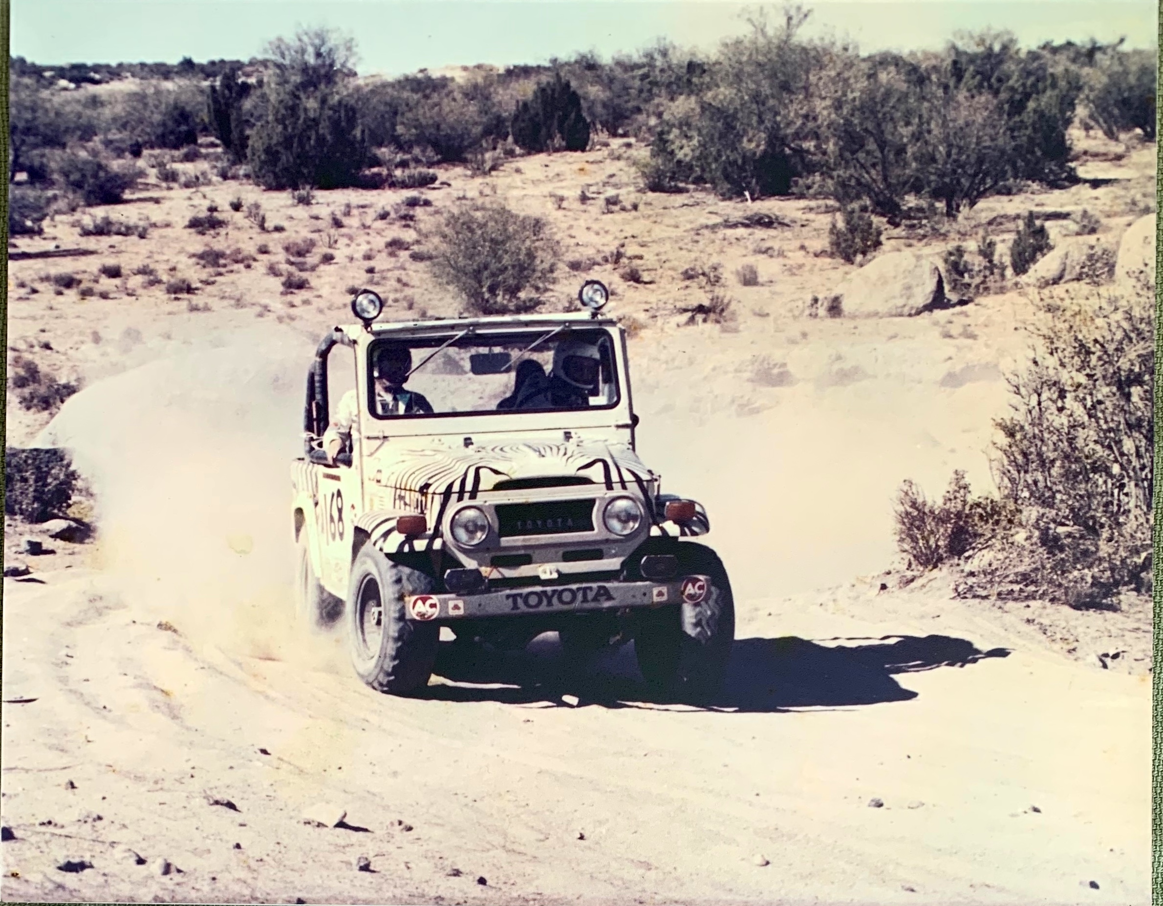 The zebra-striped Land Cruiser #168 racing in the Baja