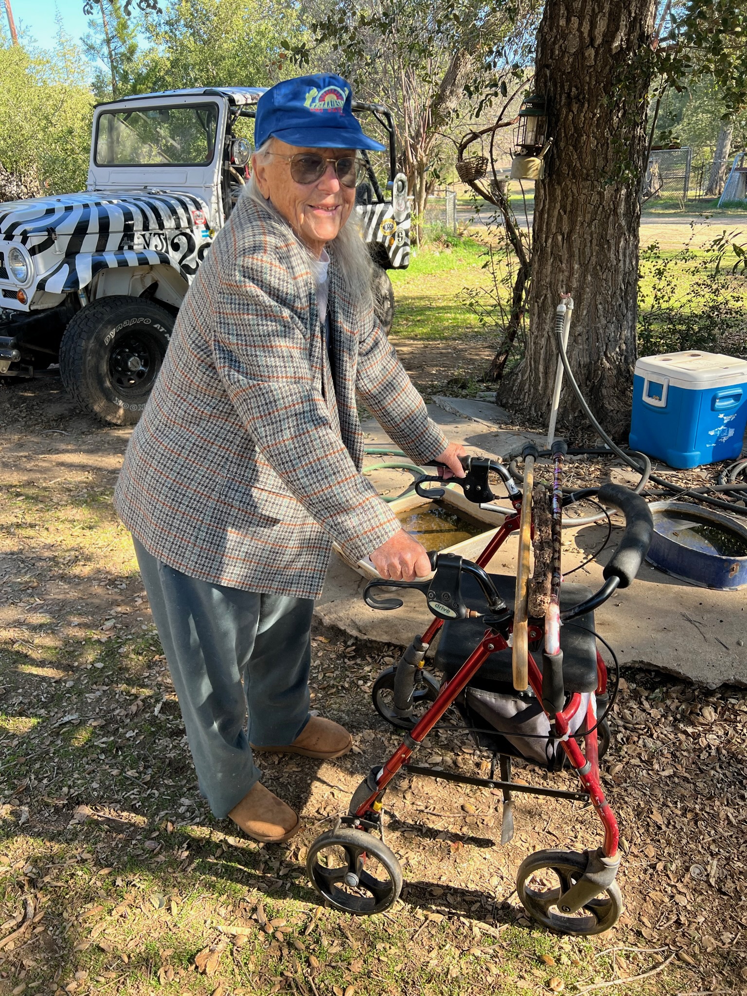 Sue standing with the zebra-striped Jeep